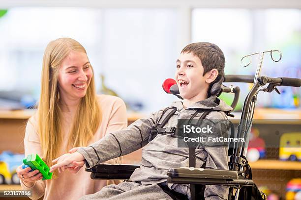 Playing With Plastic Blocks Stock Photo - Download Image Now - Concentration, Disability, Child