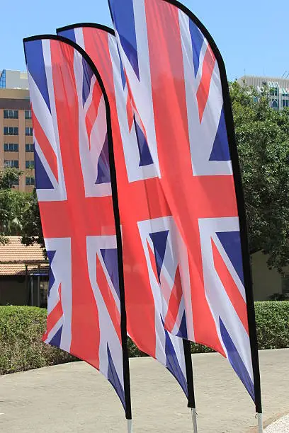 Set of three Union Jack flags blowing in the wind