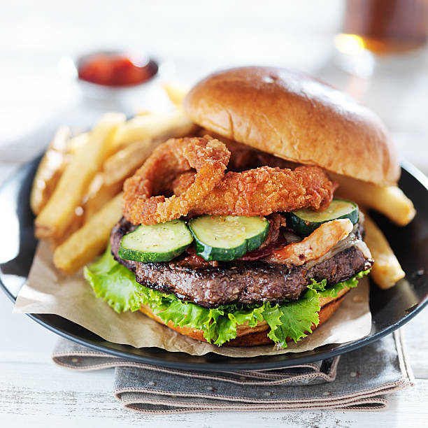 bacon cheeseburger with onions rings close up