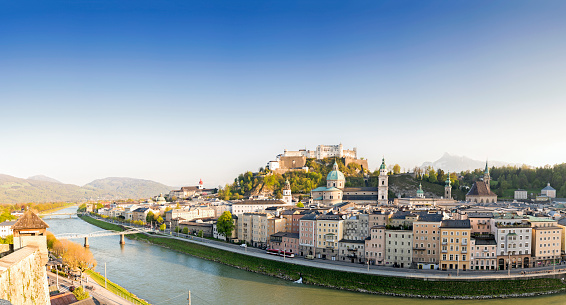 Sunny panoramic image of Salzburg's famous old town with Alps in the background