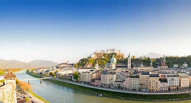 Sunny panoramic image of Salzburg's famous old town with Alps in the background