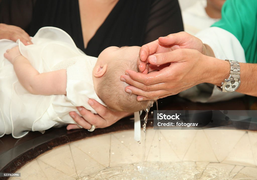 Newborn baby baptism Newborn baby baptism by water with hands of priest Baptism Stock Photo