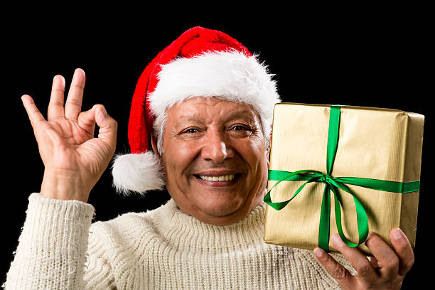 istock Grinning Male Senior With Gift Gesturing OK Sign 523162127