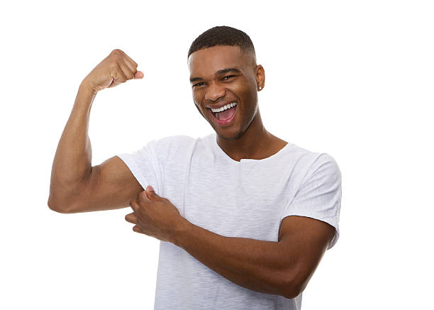 istock Happy young man flexing bicep muscle 523162295