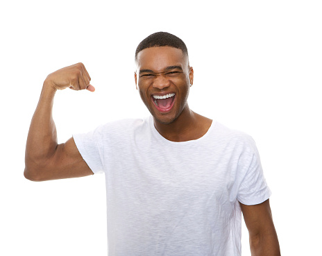 Close up portrait of a happy african american man flexing arm muscle
