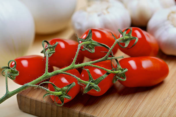 istock Cherry tomatos on a wooden board 523164263