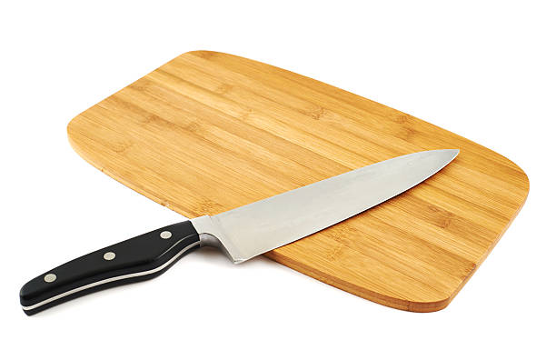 istock Knife over wooden cutting board 523164274