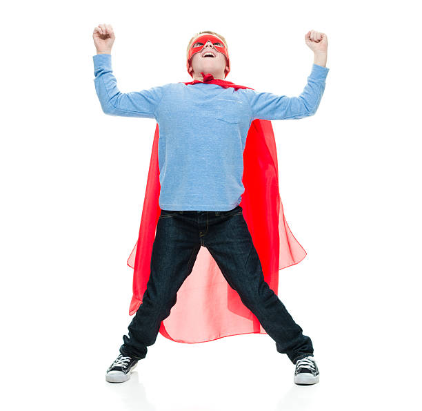istock Smiling little superhero cheering 523164616