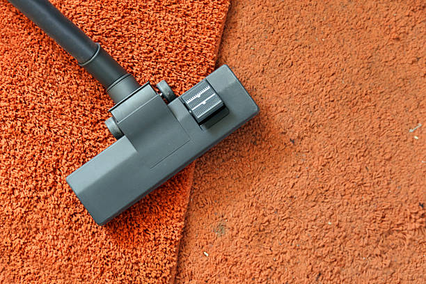 Vacuuming carpets Cleaning carpets with a vacuum cleaner - clean vs. dirty carpet. carpet sweeper stock pictures, royalty-free photos & images