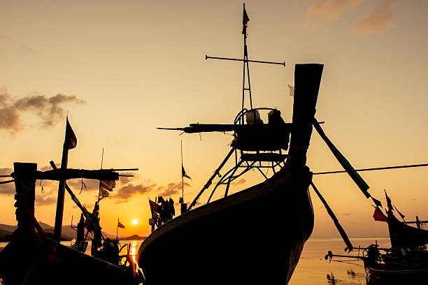 istock fishing boat at the beach sunset background 523166208