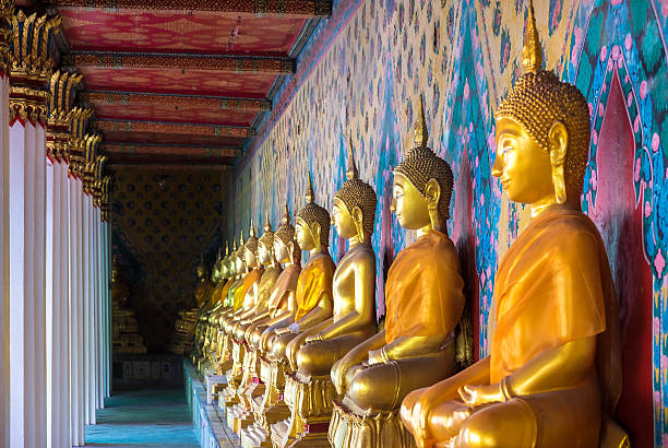 Wat Arun temple in Bangkok, Thailand Selective focus point on Buddha statue in wat arun from Bangkok, Thailand. thailand pagoda stock pictures, royalty-free photos & images