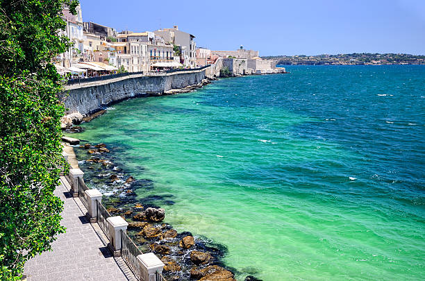 Embankment in Syracuse and the Castello Maniace in the background, Sicily, Italy. Composite photo