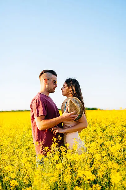 Photo of Portrait of couple in summer, hugging and kissing in nature