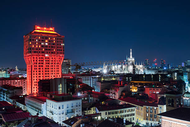 Panoramic Skyline of Milan with red illuminated Velasca Tower stock photo