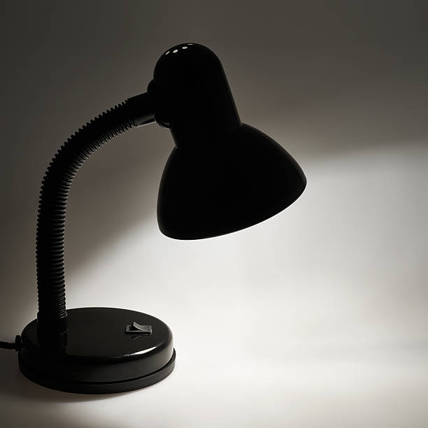 istock Black table lamp forming a circle of light 523167118