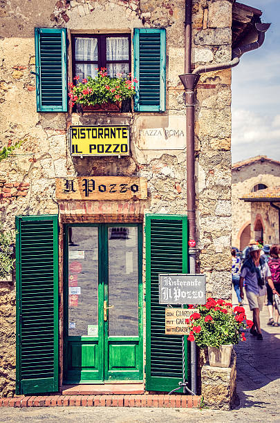 Siena, Italy, May 30, 2015: traditional tourist rustic restauran Siena, Italy, May 30, 2015: traditional tourist rustic restaurant in Monteriggioni tuscan village siena italy stock pictures, royalty-free photos & images