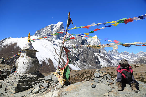 istock tabuche summit with trekker and buddhism flag from nepal 523167277