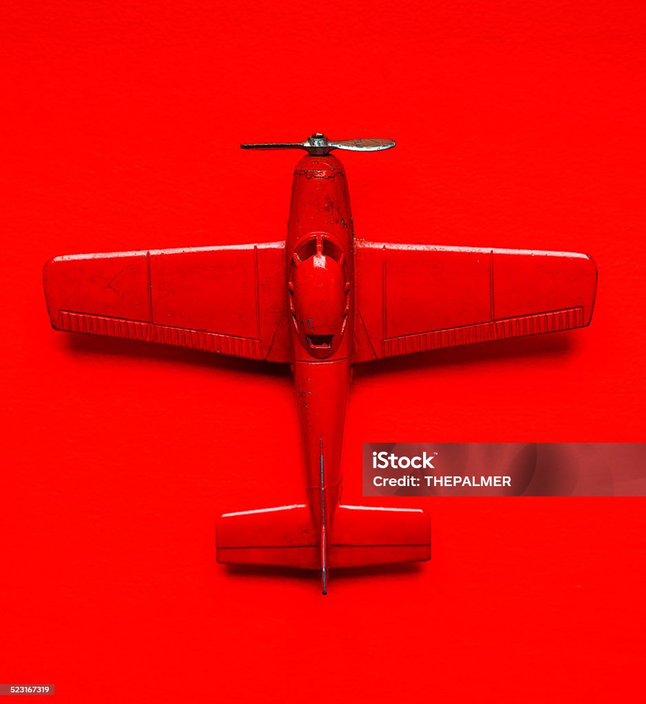 Model toy vintage airplane Vintage red airplane model metal toy  over a red background Airplane Stock Photo