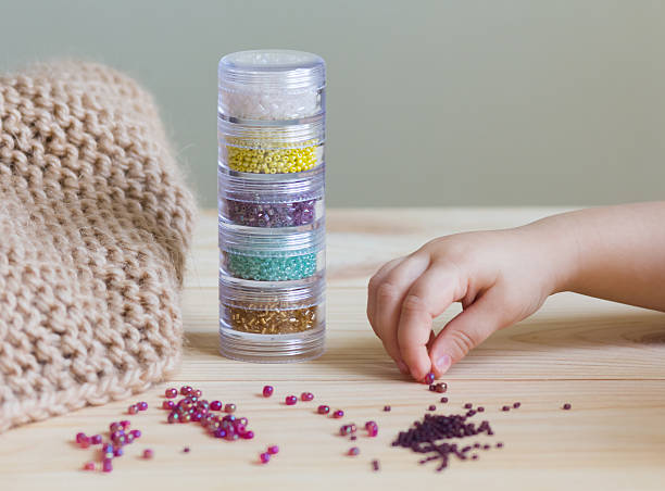 istock colorful beads and beige knitted blanket 523172478