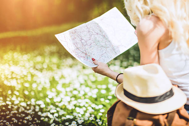 istock woman traveler reads the map 523176396