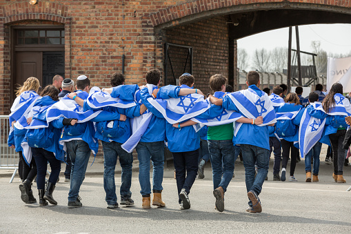 Auschwitz, Poland - April 16, 2015:   International Holocaust Remembrance Day . Annually people from the all the world meets on the March of the Living in german Concentration Camp in Auschwitz Birkenau. Poland