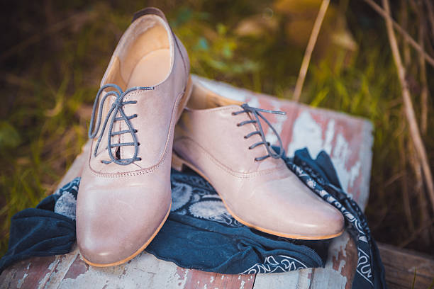 istock Women's leather shoes with laces are on a checkered tablecloth 523179193