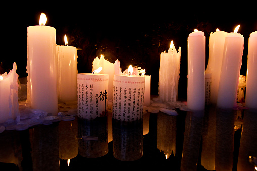 Lit candles standing on a melted candles surface make perfect reflections.