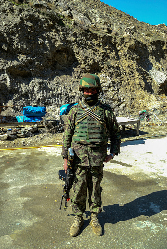 Afghan soldier with weapons and ammunition