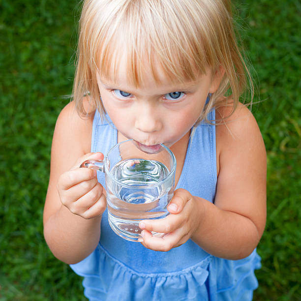 istock Child drinking water outdoors 523180454