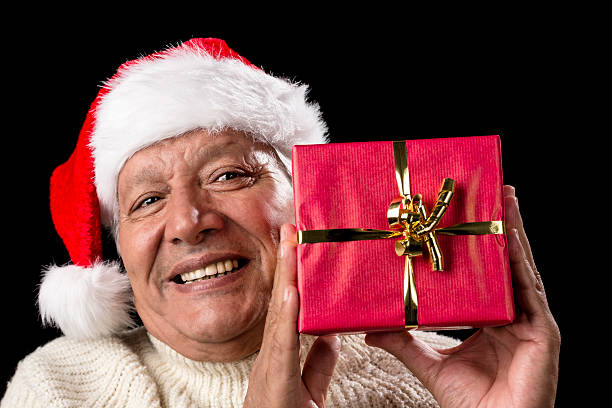 istock Smiling Old Man With Red Wrapped Christmas Gift 523180545