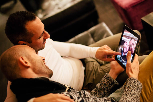 istock handsome gay couple view their selfies on a digital tablet 523182855