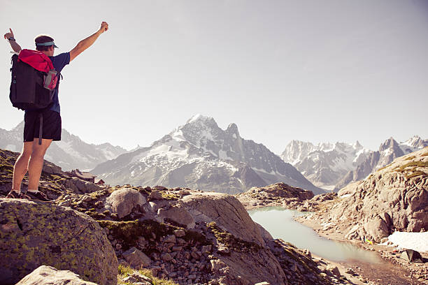 istock Cheerful male mountain top arms stretched out 523183790
