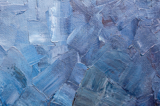 Texture of brushstrokes of blue paint on a canvas 