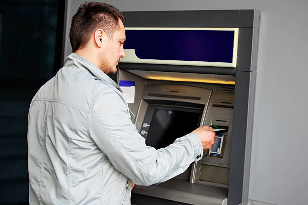 istock Man withdrawing money at the ATM machine 523185177