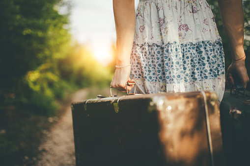 Photo of woman's hand holding traveling bag