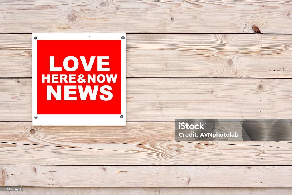 LOVE NEWS HERE AND NOW Sign LOVE NEWS HERE AND NOW Red White Sign on Timber Wall Background Advice Stock Photo