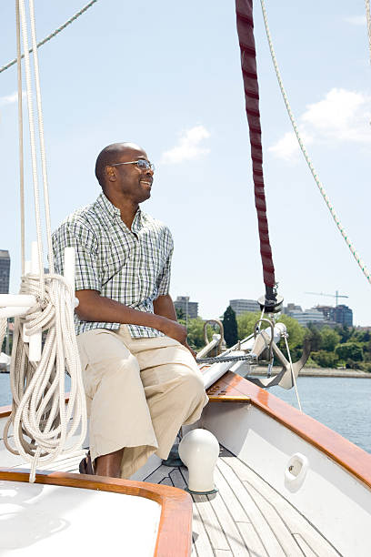 istock Man Sitting on Sailboat in Harbor 523186457