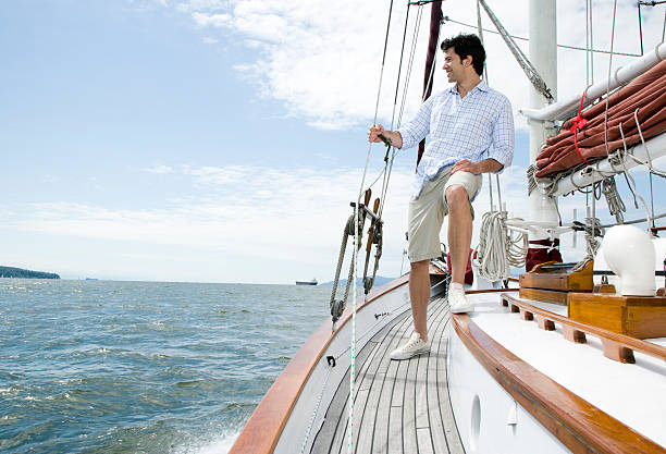 istock Man standing on deck of sailboat 523186551