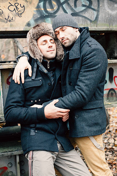 istock gay couple embracing in autumn forest 523200199