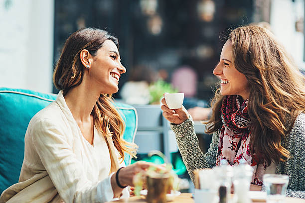 istock Young women drinking coffee and smiling 523201545