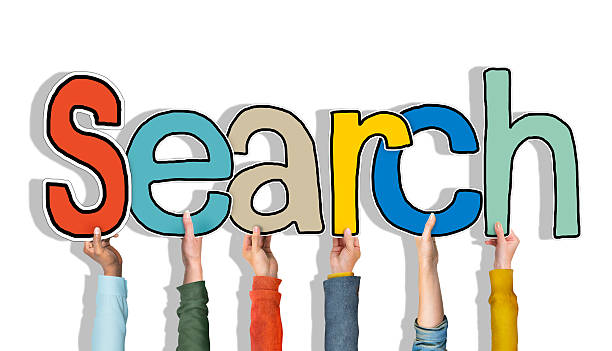istock Multiethnic Group of Hands Holding Word Search 523202449