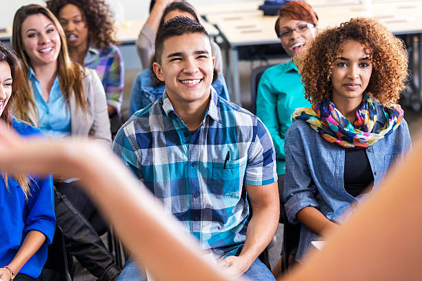istock Diverse teens listening to speaker during lecutre or orientation 523212399