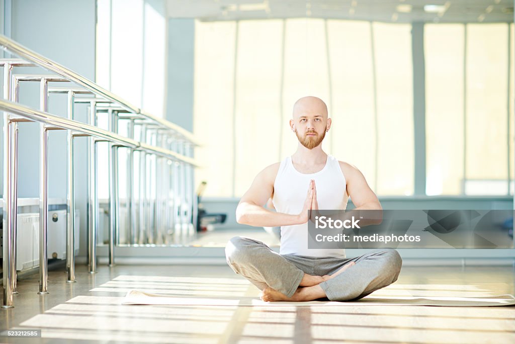 man sitting in lotus position man sitting in lotus position in gym 30-39 Years Stock Photo