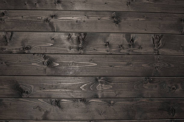 istock Dark old wooden plank fence background 523213259