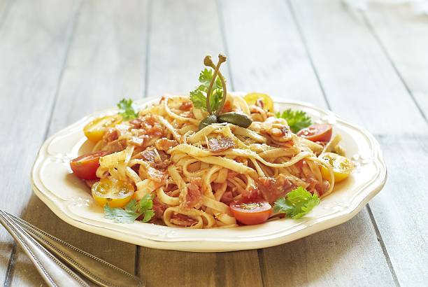 istock Pasta with tomatoes, ham, capers and cheese 523215201
