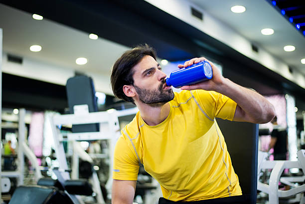 istock Young man in the gym hydrating after workout 523216335