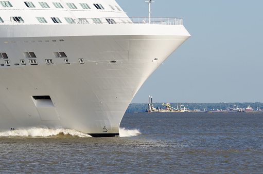 nose of a large cruise ship. White cruise liner leaving port of Saint – Petersburg