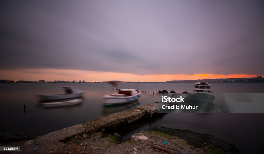 City of Istanbul A small jetty in a lake with a dramatic sky of fast moving clouds. Photographed in the blue hour at dawn. Atmospheric Mood Stock Photo