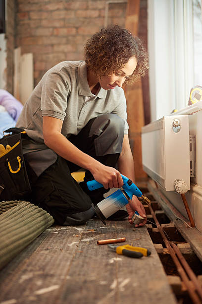 istock female plumber soldering 523236658