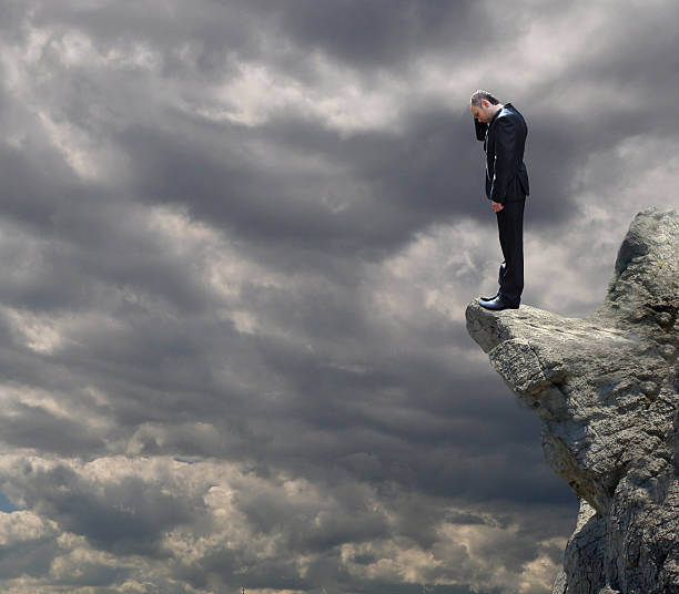 istock Businessman standing on edge mountain, 523237654